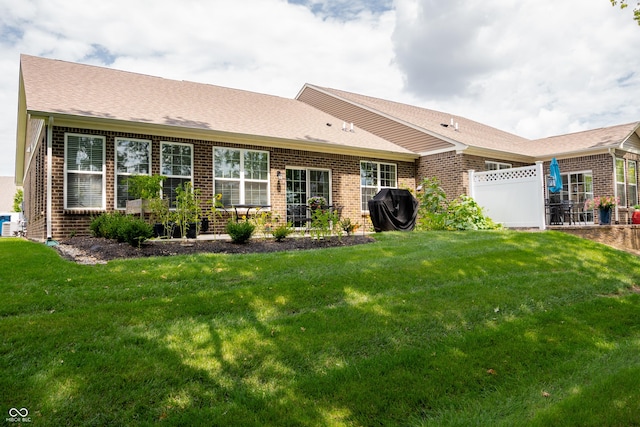 back of house featuring a yard