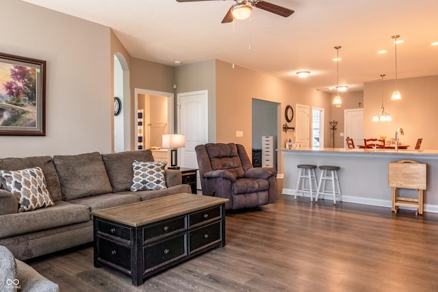 living room featuring dark hardwood / wood-style floors and ceiling fan