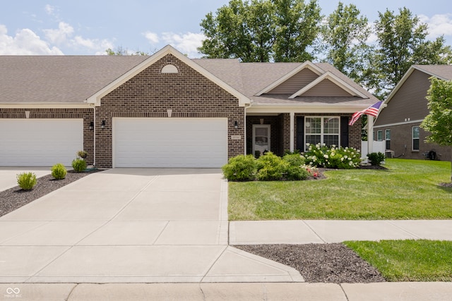 view of front of house with a garage and a front lawn