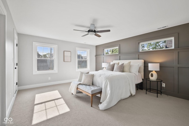 bedroom with light colored carpet and ceiling fan