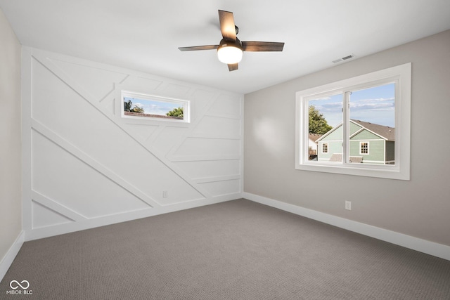 spare room featuring ceiling fan and carpet