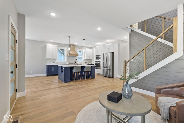 living room featuring sink and light wood-type flooring