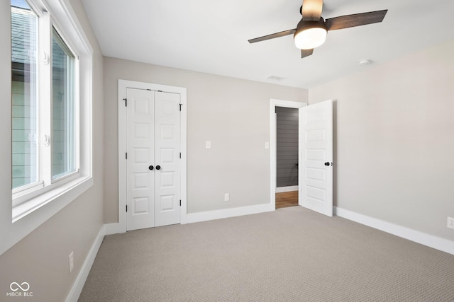 unfurnished bedroom with a closet, ceiling fan, and carpet