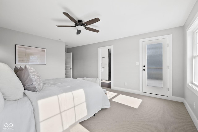 bedroom featuring ceiling fan, connected bathroom, and light carpet