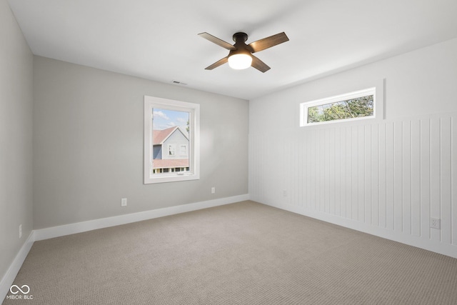 unfurnished room featuring ceiling fan and carpet