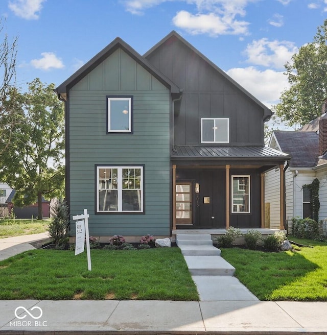 view of front of property with a porch and a front lawn