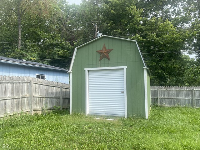 view of shed featuring fence