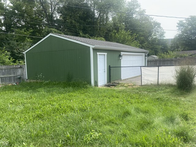 view of outbuilding featuring an outdoor structure and fence