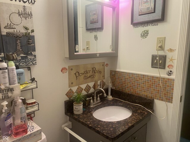 bathroom featuring decorative backsplash and vanity