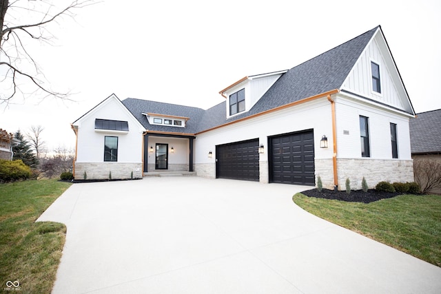 modern farmhouse style home with a garage and a front lawn