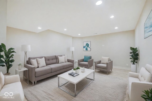 living room featuring baseboards, light wood-type flooring, and recessed lighting