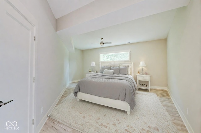 bedroom with baseboards, a ceiling fan, and light wood-style floors