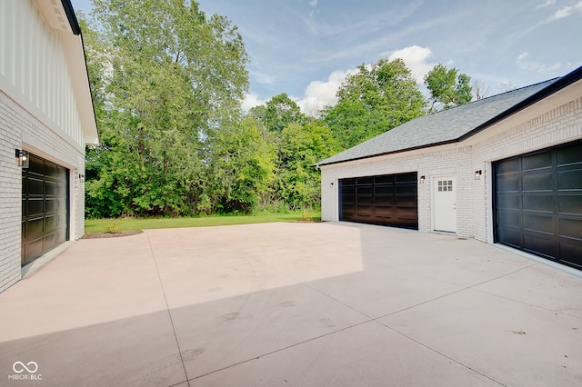 view of patio with a garage and an outdoor structure