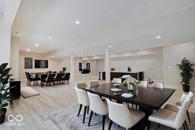 dining space featuring light wood-style flooring, baseboards, and recessed lighting