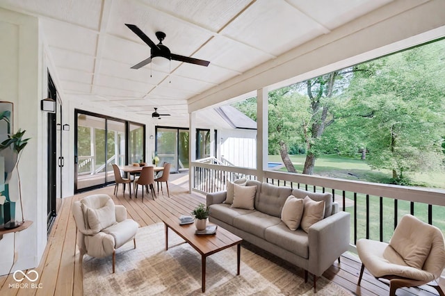 sunroom / solarium featuring ceiling fan