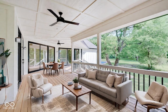 sunroom featuring a ceiling fan