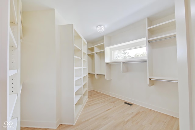 walk in closet with wood finished floors and visible vents