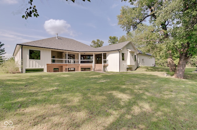 back of house with a lawn