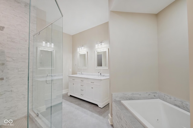 bathroom with double vanity, a stall shower, a sink, and a bath