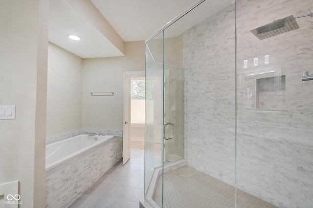 full bathroom with a stall shower, tile patterned flooring, and a bath