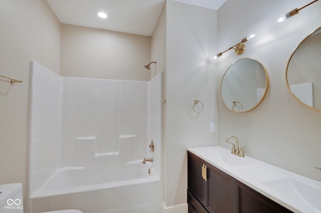 full bathroom featuring double vanity, shower / bathing tub combination, and toilet