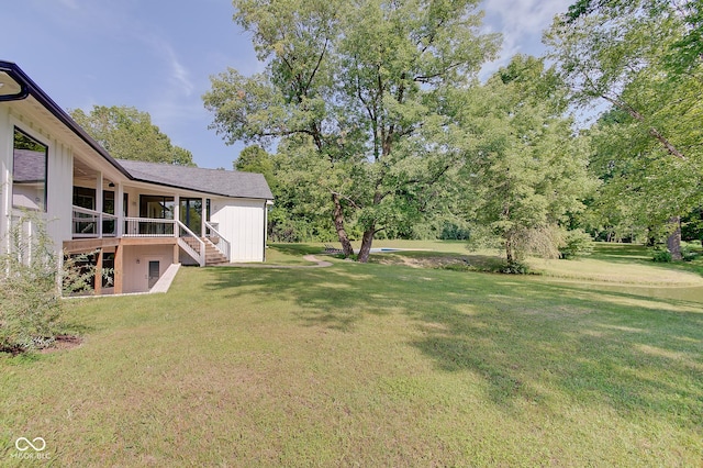 view of yard with a sunroom and stairs