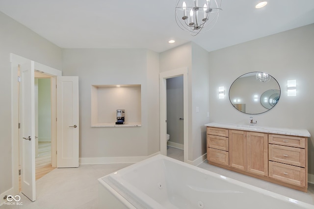 full bath with toilet, recessed lighting, vanity, baseboards, and a jetted tub