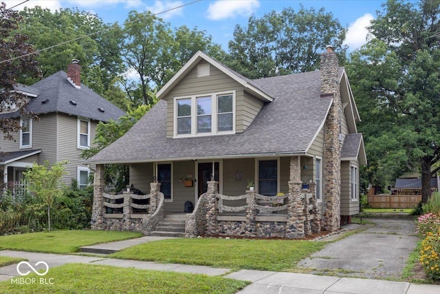 view of front of home with a front yard and a porch