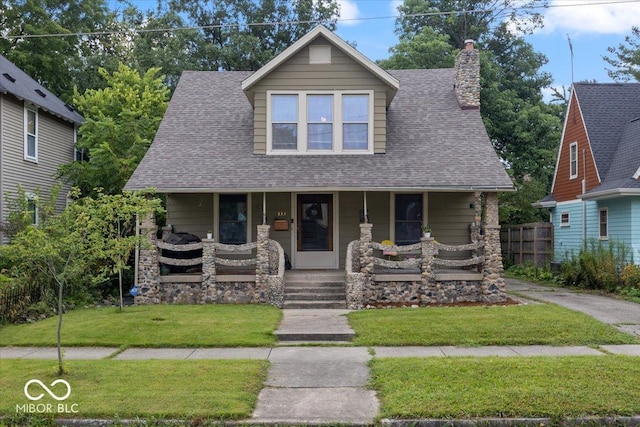 view of front of house featuring a front yard and covered porch