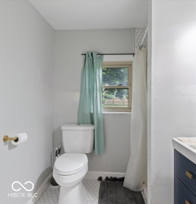 bathroom featuring vanity, toilet, and tile patterned floors