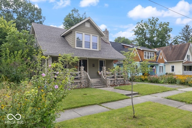 view of front of home with a porch and a front yard