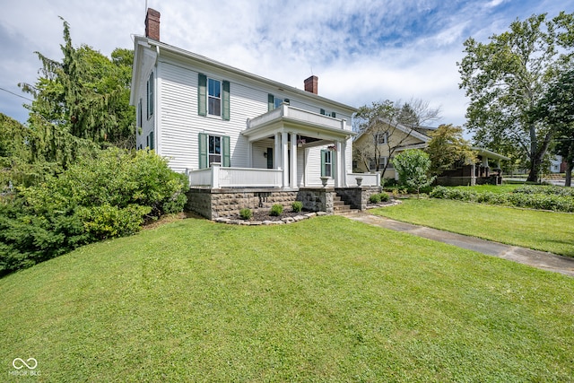 view of front of property with covered porch and a front lawn