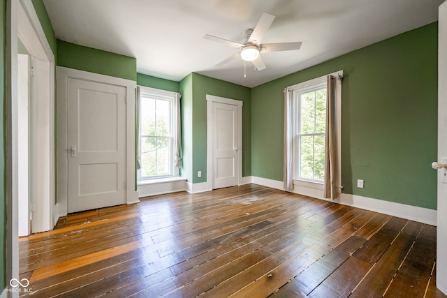 unfurnished room with ceiling fan and dark hardwood / wood-style floors