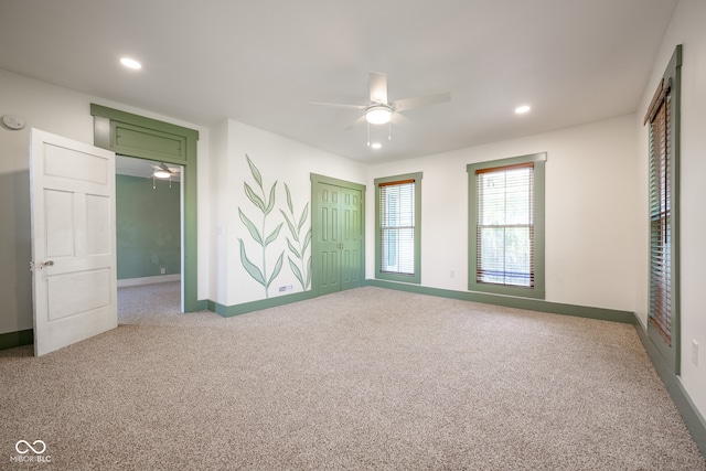 unfurnished room featuring light carpet and ceiling fan