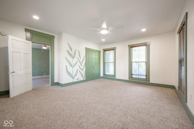 carpeted spare room featuring a ceiling fan, recessed lighting, and baseboards