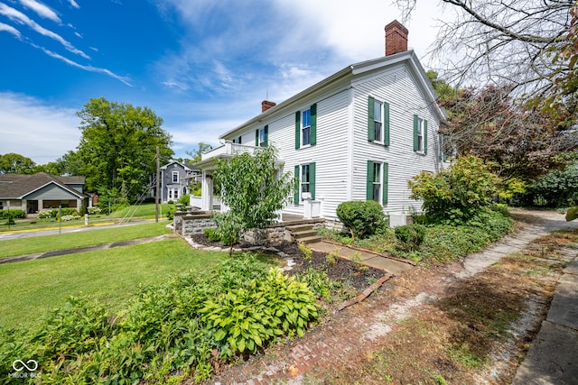 view of home's exterior with a yard