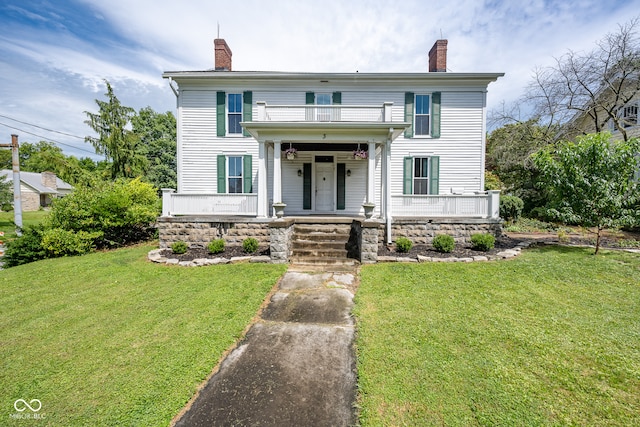 view of front of property with covered porch and a front lawn