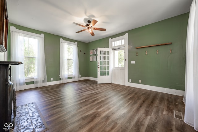 unfurnished living room with ceiling fan and hardwood / wood-style floors