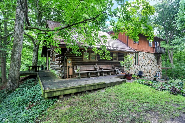 rear view of house featuring a deck