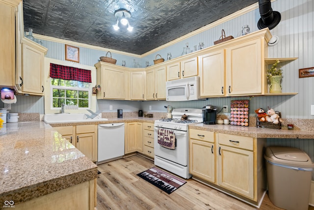 kitchen featuring white appliances, light brown cabinetry, light hardwood / wood-style flooring, ornamental molding, and sink