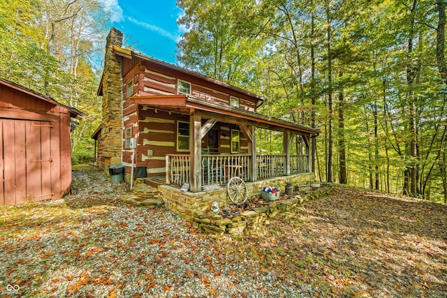 view of outdoor structure with covered porch