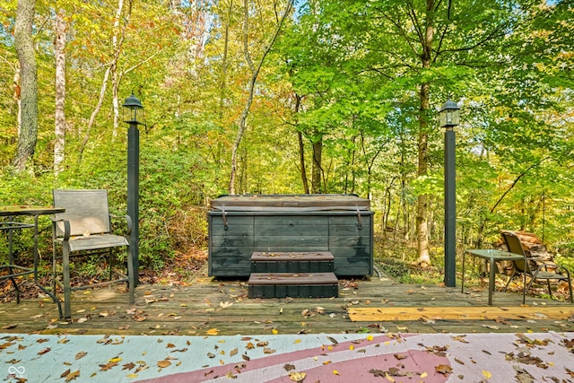 view of community featuring a jacuzzi and a deck