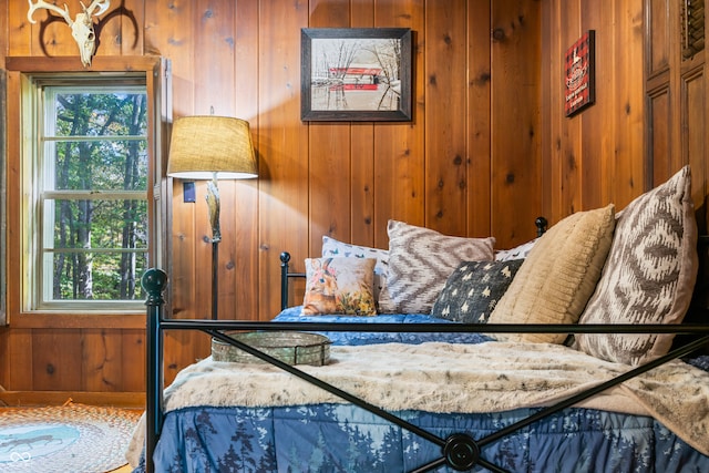 bedroom featuring wood walls