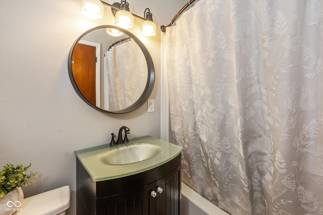 full bathroom featuring toilet, shower / bathtub combination with curtain, and vanity