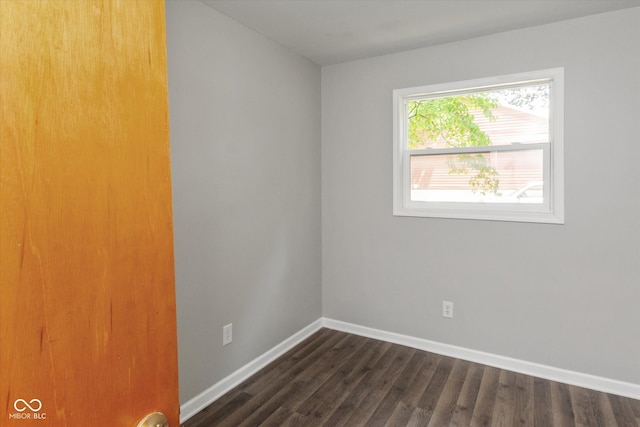 empty room featuring dark wood-type flooring