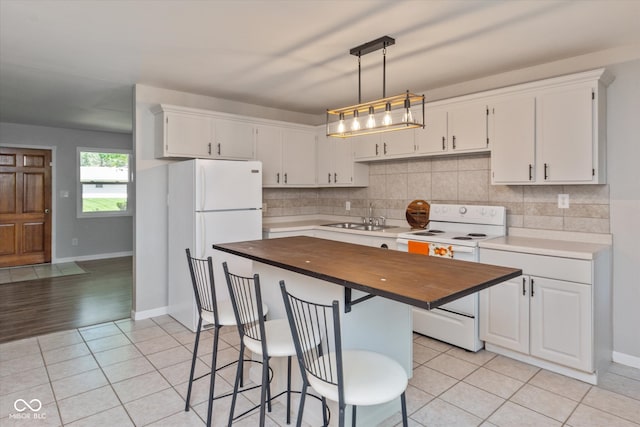 kitchen with sink, butcher block countertops, light hardwood / wood-style flooring, white appliances, and white cabinets