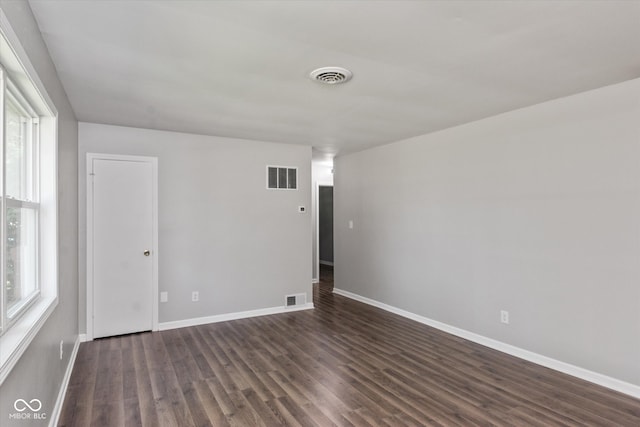 unfurnished room with a wealth of natural light and hardwood / wood-style floors