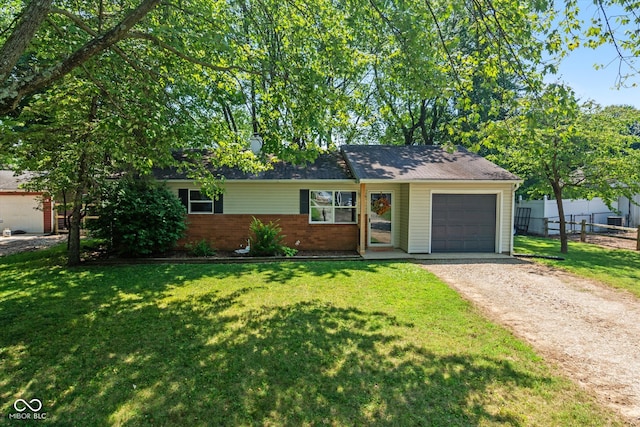 single story home featuring a garage and a front lawn