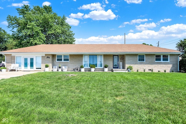 single story home with french doors and a front lawn