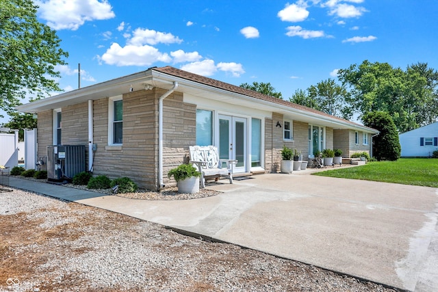 single story home with central air condition unit and french doors